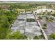 Aerial view of well-maintained tennis courts with lush landscaping and nearby parking, providing a great recreational space at 4365 Frontera Ln, Wesley Chapel, FL 33543