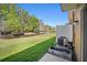 Backyard view with pond and green grass at 4535 Winding River Way, Land O Lakes, FL 34639