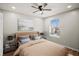 Bedroom with a ceiling fan, wood floors, a window, and neutral-toned walls at 4535 Winding River Way, Land O Lakes, FL 34639