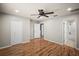 Spacious bedroom featuring wood floors, ceiling fan, and closet for ample storage at 4535 Winding River Way, Land O Lakes, FL 34639