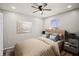 Bedroom with a ceiling fan, wood floors, a window, and neutral-toned walls at 4535 Winding River Way, Land O Lakes, FL 34639