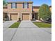 Inviting exterior of a two-story townhome with individual garage and private driveways at 4535 Winding River Way, Land O Lakes, FL 34639
