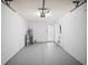 Spacious two car garage with freshly painted walls and epoxy flooring offers ample storage space at 4535 Winding River Way, Land O Lakes, FL 34639