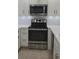 Contemporary kitchen featuring stainless steel appliances and stylish white cabinetry at 4535 Winding River Way, Land O Lakes, FL 34639