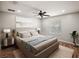 Comfortable main bedroom featuring a ceiling fan, wood floors, and a sunlit window at 4535 Winding River Way, Land O Lakes, FL 34639