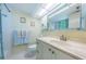 Bright bathroom with a vanity, marble countertop, and a well-lit shower-tub combination, creating a refreshing space at 4550 Cove Cir # 502, St Petersburg, FL 33708