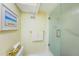 Bright bathroom with a glass-enclosed shower, towel bar, and toilet, designed for both convenience and efficiency at 4550 Cove Cir # 502, St Petersburg, FL 33708