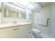 Well-lit bathroom with a vanity, sleek countertop, and a clean toilet, creating an inviting and functional space at 4550 Cove Cir # 502, St Petersburg, FL 33708