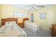 Cozy bedroom featuring twin beds, floral bedding, carpeted floor, and a ceiling fan for comfortable rest and relaxation at 4550 Cove Cir # 502, St Petersburg, FL 33708