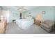 Relaxing bedroom with soft carpet, ceiling fan and coastal touches, with walk-in closet at 4550 Cove Cir # 502, St Petersburg, FL 33708