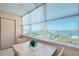 Bright dining area with expansive water and city views from multiple windows at 4550 Cove Cir # 502, St Petersburg, FL 33708