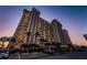 Modern condominium building shows multiple stories of balconies and parking area with tropical landscaping at 4550 Cove Cir # 502, St Petersburg, FL 33708