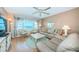 Spacious living room shows water view, ceiling fan and comfortable seating at 4550 Cove Cir # 502, St Petersburg, FL 33708