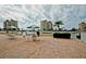 Relaxing patio area with tables, chairs, and umbrellas overlooking the tranquil water and condo buildings at 4550 Cove Cir # 502, St Petersburg, FL 33708