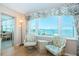 Inviting sitting area with large windows offering stunning water views and two cozy chairs at 4550 Cove Cir # 502, St Petersburg, FL 33708