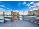 Waterfront deck with seating offering scenic views of the water and surrounding buildings under a bright sky at 4550 Cove Cir # 502, St Petersburg, FL 33708