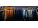 Stunning night view of waterfront condo buildings with lights reflecting beautifully on the calm water at 4550 Cove Cir # 502, St Petersburg, FL 33708