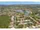Beautiful aerial view of a neighborhood featuring mature landscaping, a large lake, and homes with pools at 5269 White Sand Ne Cir, St Petersburg, FL 33703