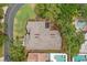 Aerial view of a well-maintained roof and solar panels surrounded by lush greenery and trees at 5269 White Sand Ne Cir, St Petersburg, FL 33703
