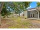 Fenced backyard showing a view of home and screened-in patio surrounded by mature trees at 5269 White Sand Ne Cir, St Petersburg, FL 33703