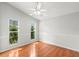 A large bedroom with two bright windows, light walls, and attractive wood flooring at 5269 White Sand Ne Cir, St Petersburg, FL 33703