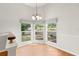 Bright dining room features hardwood floors and natural light through large windows at 5269 White Sand Ne Cir, St Petersburg, FL 33703