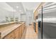Long kitchen with stainless steel appliances, granite counters, and wood cabinets at 5269 White Sand Ne Cir, St Petersburg, FL 33703