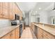 Full kitchen view features wood cabinets, granite countertops and stainless steel appliances at 5269 White Sand Ne Cir, St Petersburg, FL 33703