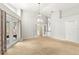 Bright living room with carpet, high ceiling, access to the backyard and open views into other rooms at 5269 White Sand Ne Cir, St Petersburg, FL 33703