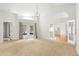 Open-concept living room featuring neutral carpet, access to the backyard, and open views to other areas at 5269 White Sand Ne Cir, St Petersburg, FL 33703