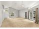 Spacious living room with neutral carpet, a high ceiling, access to the backyard, and ample natural light at 5269 White Sand Ne Cir, St Petersburg, FL 33703