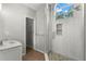 Main bathroom featuring tile shower, decorative window and marble countertop vanity at 5269 White Sand Ne Cir, St Petersburg, FL 33703