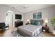 Well-lit main bedroom features a TV, dresser, nightstands and ensuite bathroom at 5269 White Sand Ne Cir, St Petersburg, FL 33703