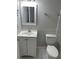 Bathroom with a white sink, vanity, toilet, and a mirror with lighting, offering a clean and functional design at 5768 75Th N Ter, Pinellas Park, FL 33781