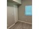 Simple bedroom featuring gray walls, wood floors, a window with blinds, and a closet at 5768 75Th N Ter, Pinellas Park, FL 33781