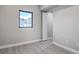 Bedroom with neutral gray walls, trim and flooring, with a window and doorway at 5768 75Th N Ter, Pinellas Park, FL 33781
