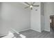 Bedroom features a ceiling fan, neutral gray walls and trim, with light gray flooring at 5768 75Th N Ter, Pinellas Park, FL 33781