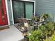 Inviting front porch with outdoor seating, plants, and a red front door, enhancing curb appeal at 5768 75Th N Ter, Pinellas Park, FL 33781