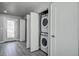 Hallway featuring a stacked washer and dryer combo concealed behind folding closet doors at 5768 75Th N Ter, Pinellas Park, FL 33781