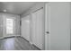 Hallway with multiple closets and a glass paneled door, with gray flooring at 5768 75Th N Ter, Pinellas Park, FL 33781