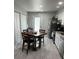 Functional kitchen boasts white cabinets, stainless steel appliances, a dining area, and access to outdoor space at 5768 75Th N Ter, Pinellas Park, FL 33781