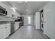 Modern kitchen with stainless steel appliances, granite countertops, and a washer/dryer closet at 5768 75Th N Ter, Pinellas Park, FL 33781