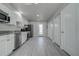 Modern kitchen featuring stainless steel appliances, gray granite countertops, and ample white cabinet space at 5768 75Th N Ter, Pinellas Park, FL 33781