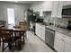 Functional kitchen boasts white cabinets, stainless steel appliances, a dining area, and access to outdoor space at 5768 75Th N Ter, Pinellas Park, FL 33781