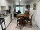 Functional kitchen boasts white cabinets, stainless steel appliances, a dining area, and access to outdoor space at 5768 75Th N Ter, Pinellas Park, FL 33781