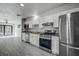 Bright kitchen features modern stainless steel appliances, white cabinets, and gray countertops at 5768 75Th N Ter, Pinellas Park, FL 33781
