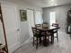 Functional kitchen boasts white cabinets, stainless steel appliances, a dining area, and access to outdoor space at 5768 75Th N Ter, Pinellas Park, FL 33781