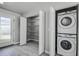 Laundry closet featuring shelving and a stacked washer and dryer combo in a hallway at 5768 75Th N Ter, Pinellas Park, FL 33781