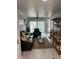 Inviting living room features a plush leather sofa, ceiling fan, and sliding glass doors to outdoor space at 5768 75Th N Ter, Pinellas Park, FL 33781