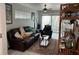 Inviting living room features a plush leather sofa, ceiling fan, and sliding glass doors to outdoor space at 5768 75Th N Ter, Pinellas Park, FL 33781